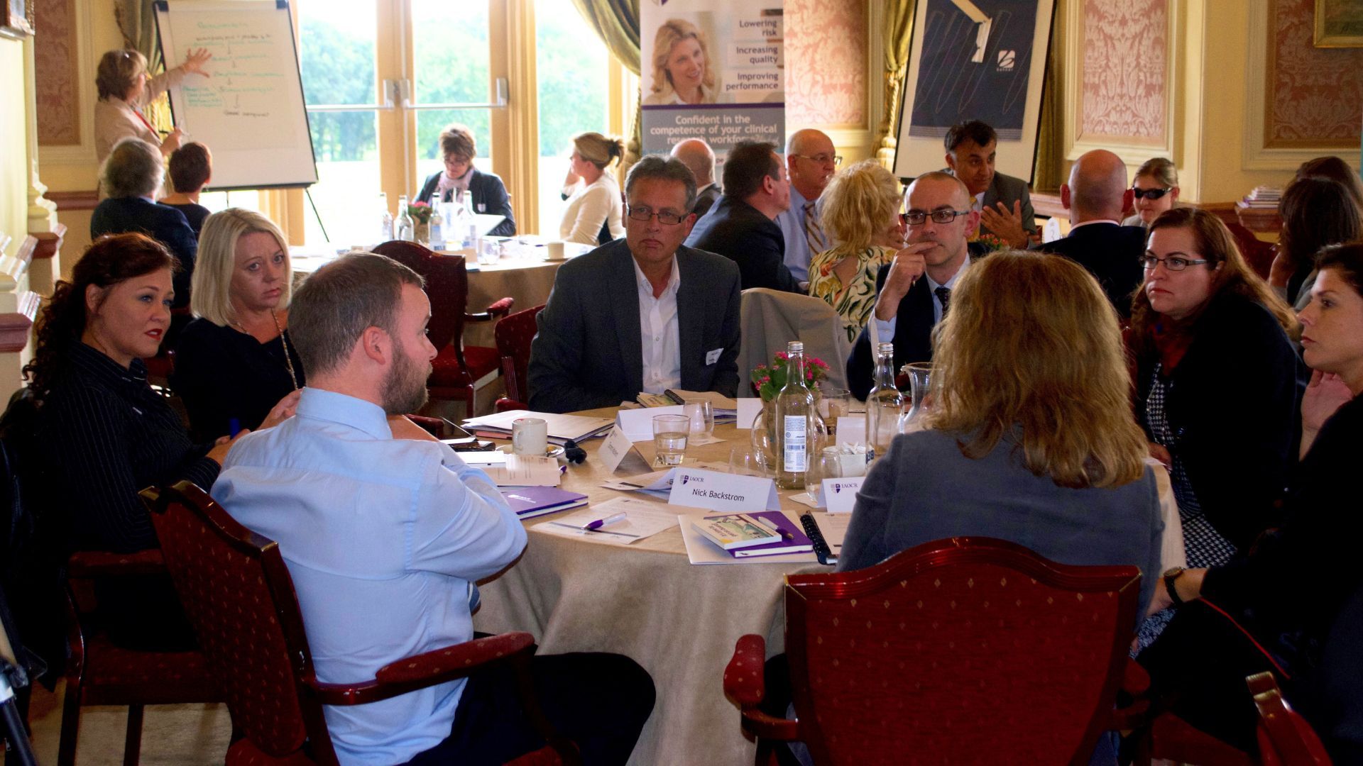 Professionals at a conference talking