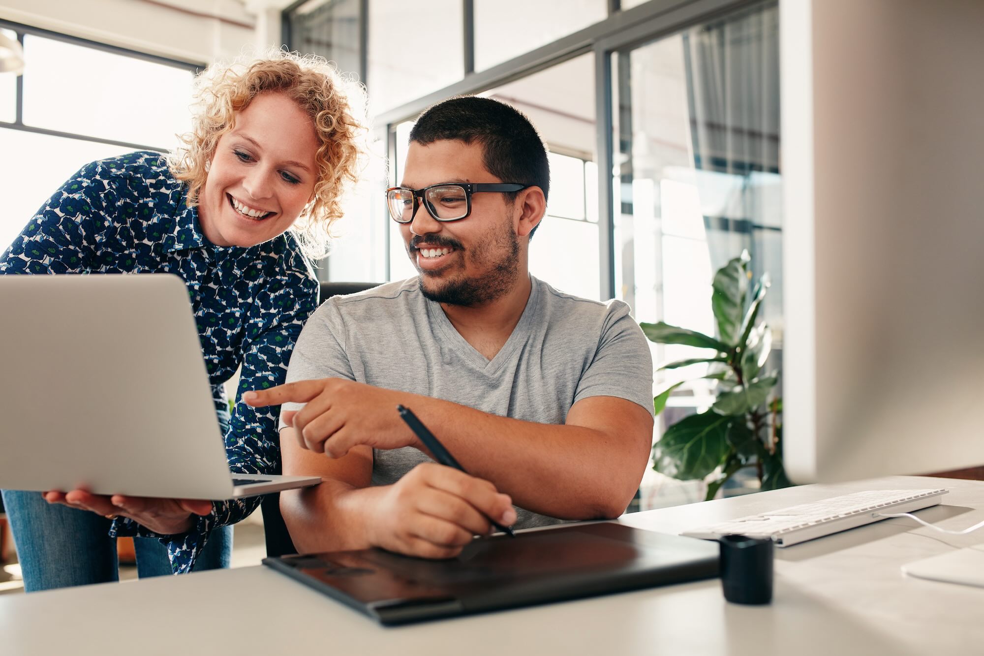 clinical research career advice given to office coworker hovering over laptop